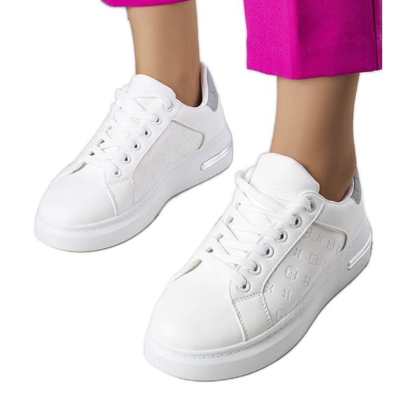 A Tasha fehér, magas talpú tornacipői