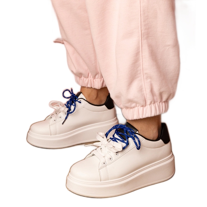 Fehér sport cipők a platformon