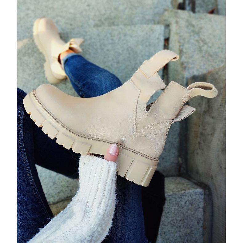 Világos bézs színű női csizma az emelvényen 1